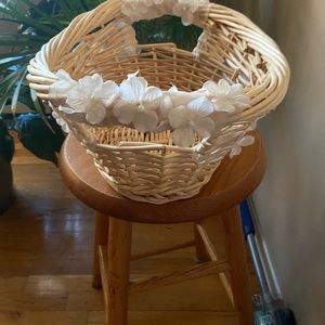 Wicker Basket decorated with fake white flowers.